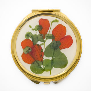 Espejo con pétalos de San Miguelito y hierba silvestre